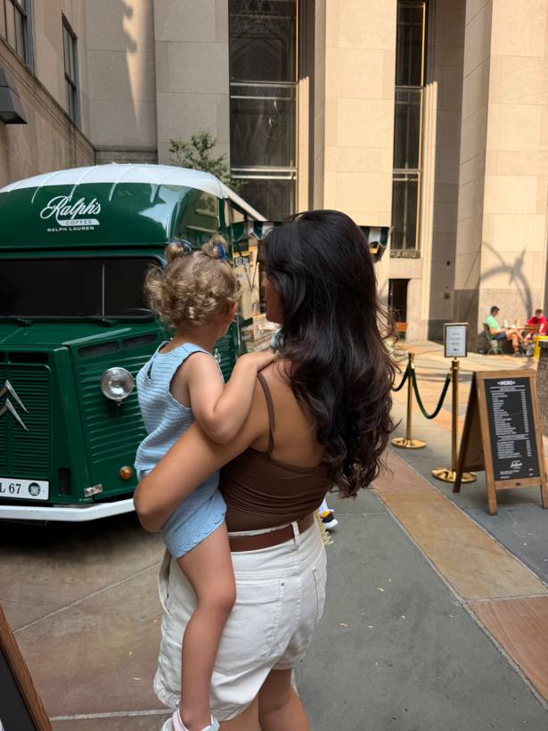 Bea carrying her daughter on an everyday outing